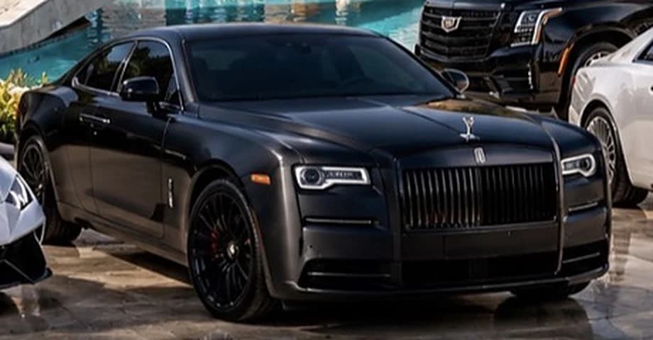 Black Rolls-Royce fastback coupé with dark wheels, front three-quarter view